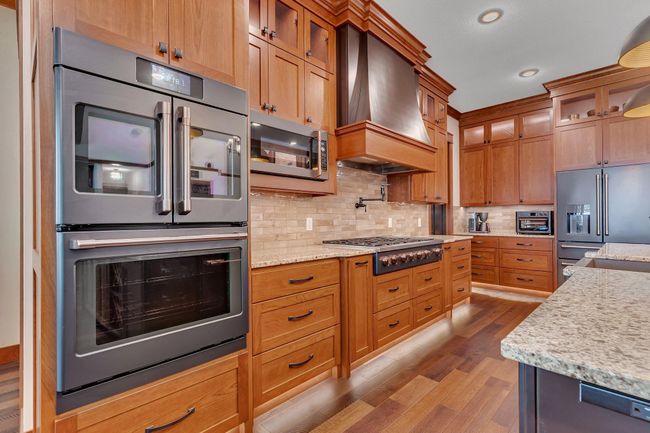 Chef’s kitchen featuring a professional 6-burner gas range with a griddle, perfect for preparing meals with precision and ease. | Image 37