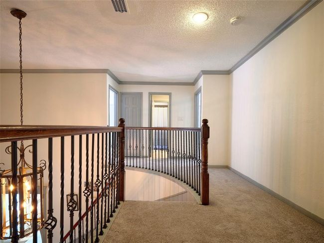 The updated wrought iron balusters make this spiral staircase a standout feature. | Image 17