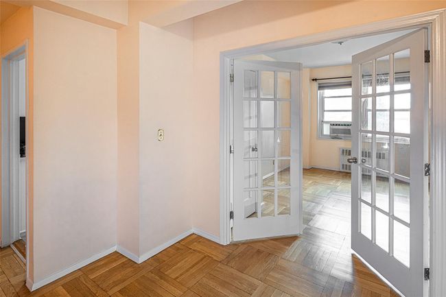 French doors and a closet have been installed to enhance the versitility of this space. Originally laid out to be a formal dining room, it can be an office, a den or an additional bedroom space. | Image 9