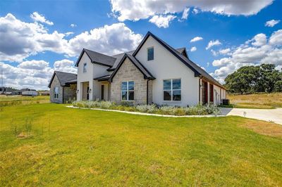 Front of home featuring side entry garage | Image 1