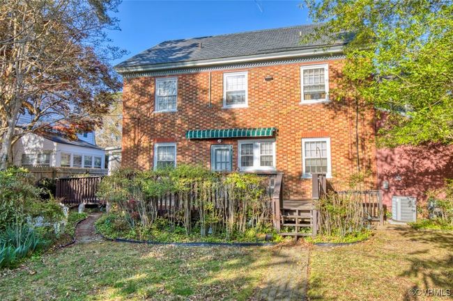 Back of house featuring brick siding and a lawn | Image 9