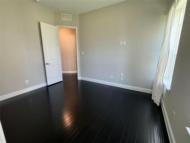 Spare room featuring baseboards and dark wood-style floors | Image 29