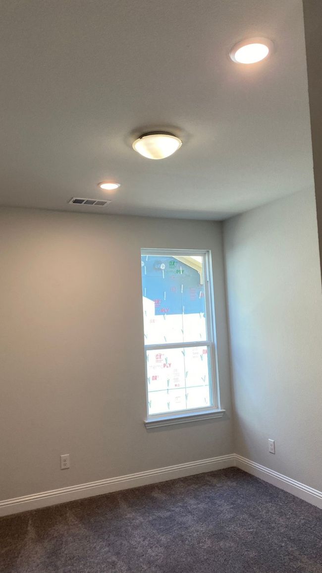 Unfurnished room with dark colored carpet, baseboards, and recessed lighting | Image 12