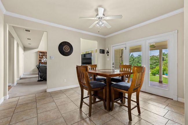 Breakfast area with doors to the back yard ad outdoor kitchen. | Image 13