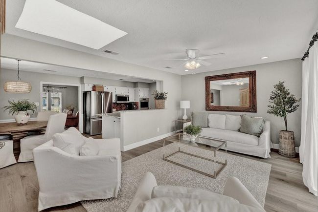 Living room featuring baseboards, visible vents, and light wood-style flooring | Image 11