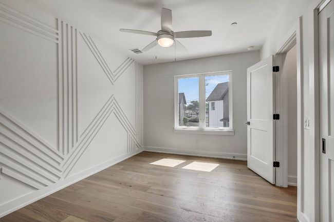 Unfurnished bedroom with light wood-style floors, a ceiling fan, and baseboards | Image 14