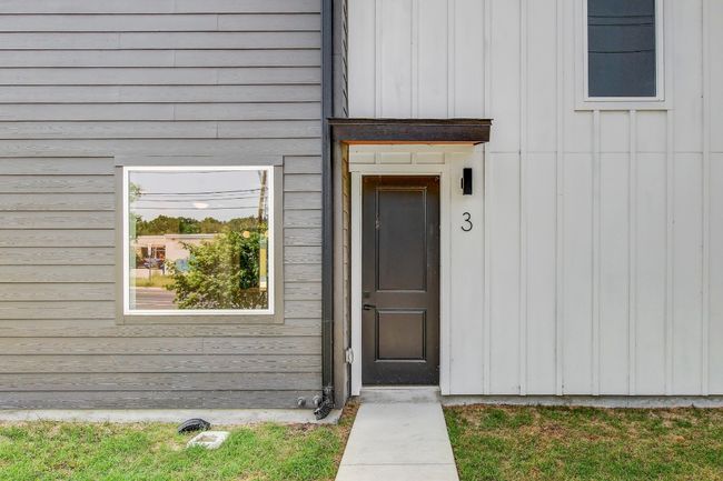 Property entrance with board and batten siding | Image 29