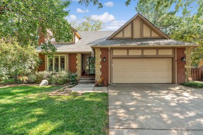 View of front of property with a garage and a front lawn | Image 1