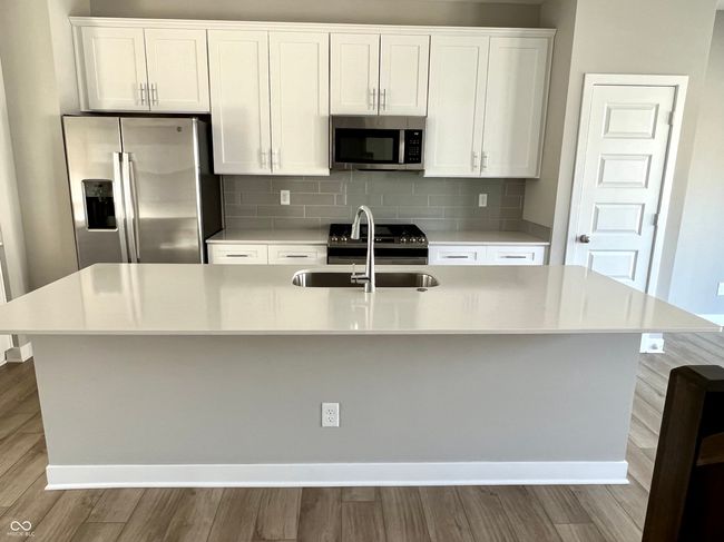 Gourmet chef's kitchen with SS appliances, gas range, Shelf Genie cabinet system, quartz countertops. | Image 16