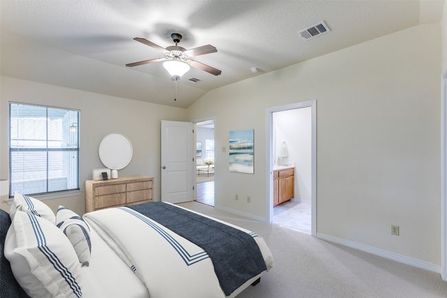 Bedroom with light carpet, lofted ceiling, ensuite bath, and a ceiling fan | Image 36