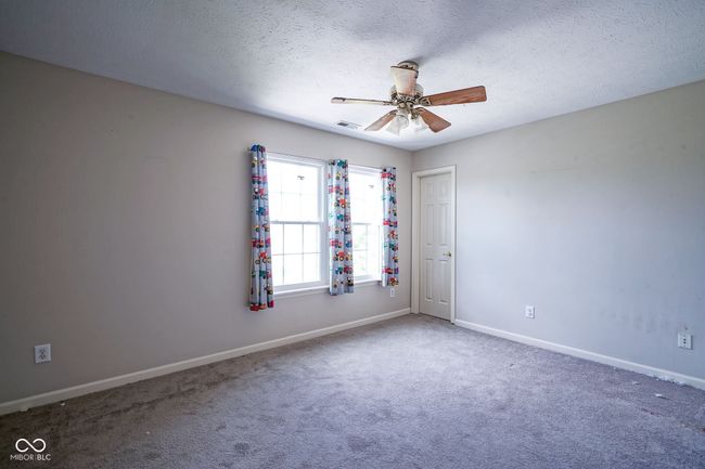unfurnished room featuring ceiling fan, a textured ceiling, and carpet | Image 29