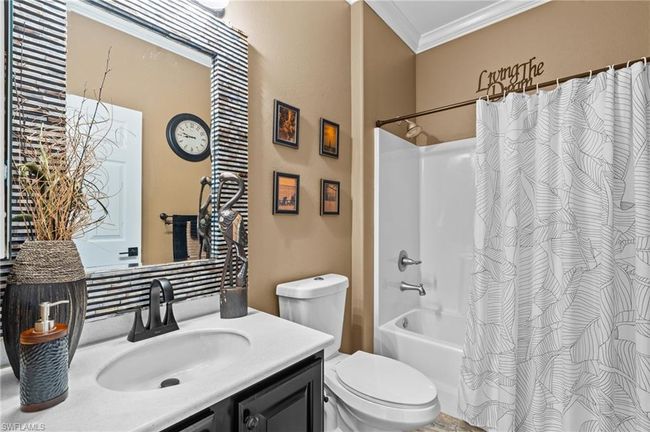Bathroom with ornamental molding, vanity, toilet, and shower / tub combo | Image 33