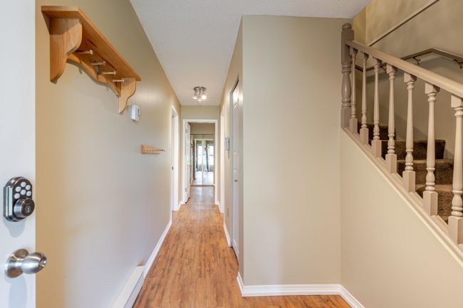 Hall with baseboards, stairway, and light wood-type flooring | Image 28