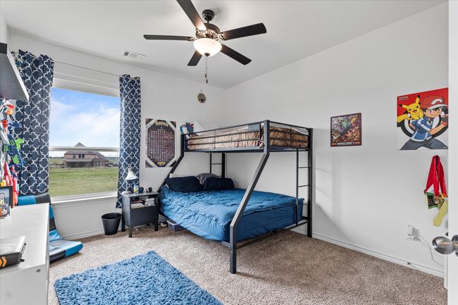 Bedroom with carpet floors, visible vents, a ceiling fan, and baseboards | Image 27