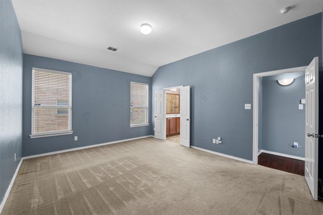 Unfurnished bedroom with visible vents, baseboards, vaulted ceiling, and carpet floors | Image 11