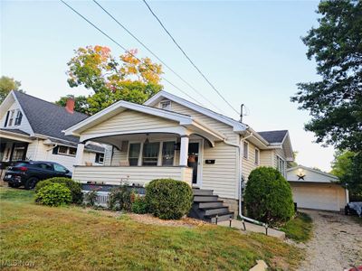 Bungalow featuring a garage and a front lawn | Image 2