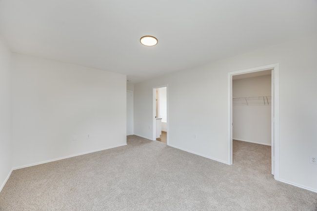 Unfurnished bedroom with light colored carpet, a spacious closet, and a closet | Image 30