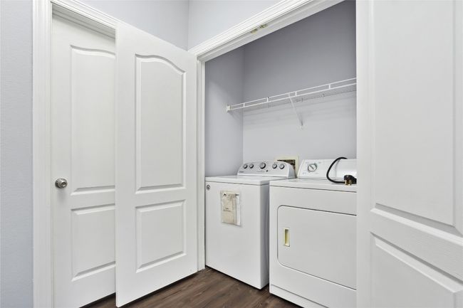 Laundry area with dark wood finished floors, laundry area, and washer and dryer | Image 10