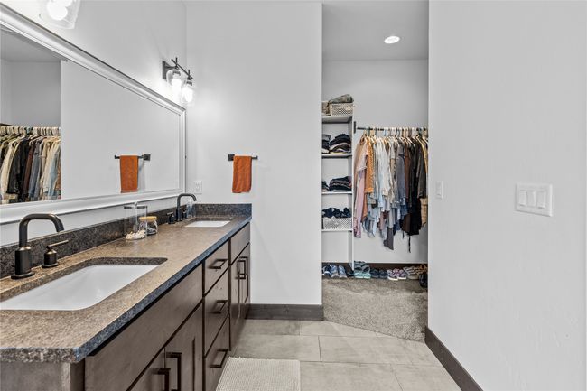 Full bathroom featuring double vanity, a sink, and baseboards | Image 27