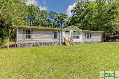 Front with fence with gate to the left. | Image 2