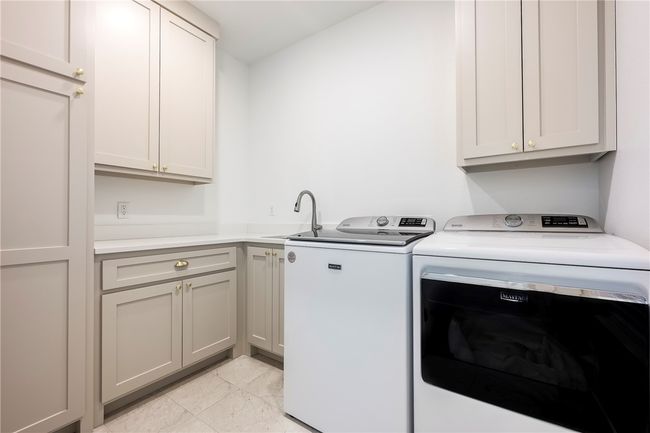 Spacious laundry with extra storage. | Image 26