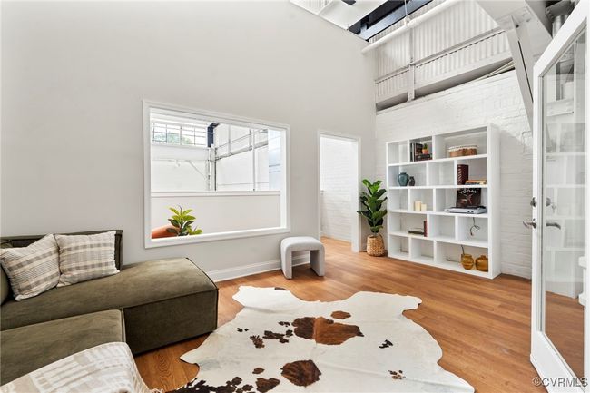 Sitting room with wood finished floors and baseboards | Image 19