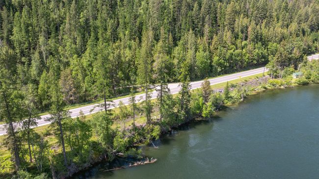 Aerial view of property and surrounding area with a heavily wooded area | Image 52