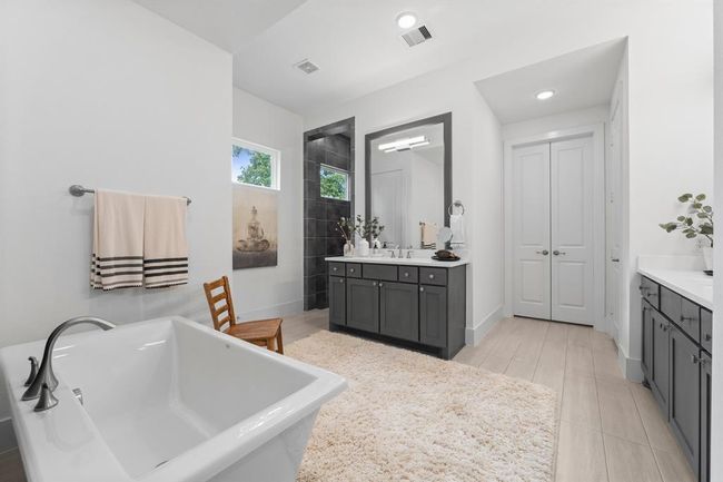 Primary bath offers his and hers vanities | Image 29