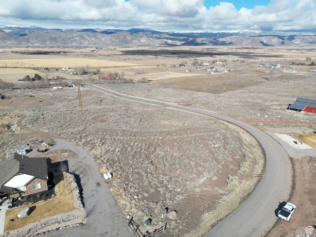 Aerial view of property's location featuring a mountain backdrop and rural landscape | Image 11