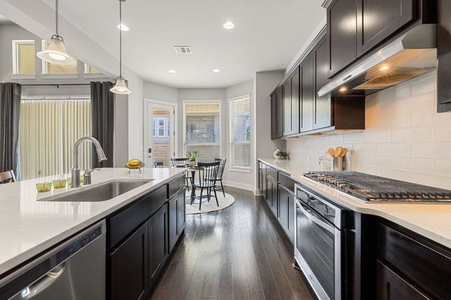 A good kitchen that is fun to cook in. Pretty wood cabinets and quartz counters. | Image 7