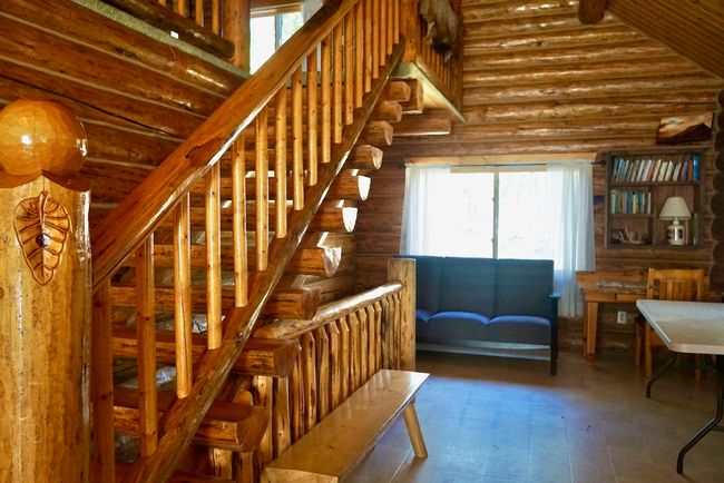 Staircase with high vaulted ceiling and log walls | Image 24