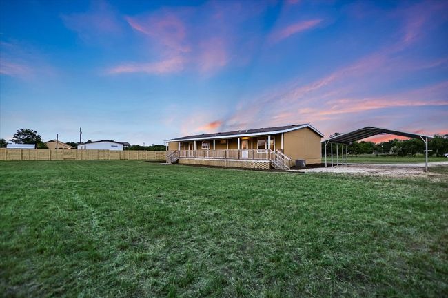 View of front of property featuring a detached carport and a porch | Image 18