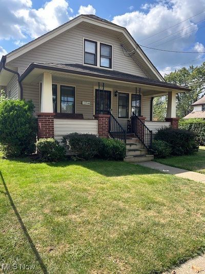 Bungalow-style house with a front yard and a porch | Image 1