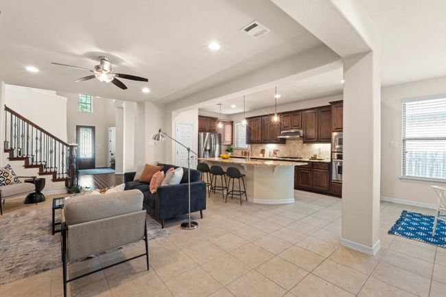 Living room featuring plenty of natural light, stairs, recessed lighting, light tile patterned flooring, and ceiling fan | Image 8