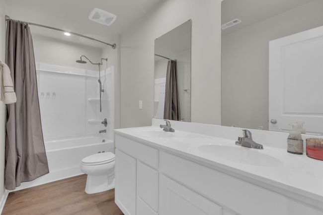 The upstairs common bathroom is perfectly designed to accommodate three of the four upstairs bedrooms, featuring a convenient double vanity, and upgraded showerhead, and even a bidet for added comfort and luxury. | Image 37