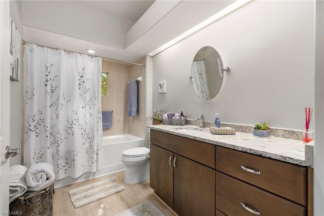 Full bathroom with hardwood / wood-style flooring, vanity, toilet, and shower / tub combo | Image 18