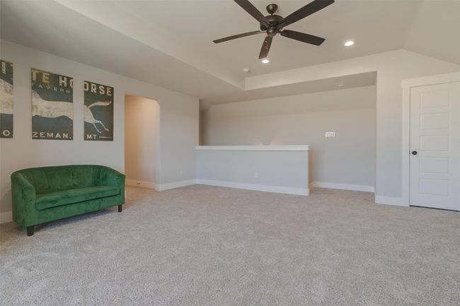 Sitting room featuring ceiling fan and light colored carpet | Image 28