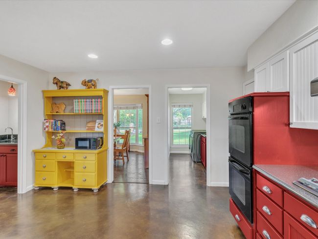 Kitchen featuring a sink, baseboards, concrete flooring, recessed lighting, and stainless steel gas stovetop | Image 16
