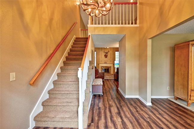 Welcoming foyer with elegant staircase, leading to spacious living areas. | Image 5