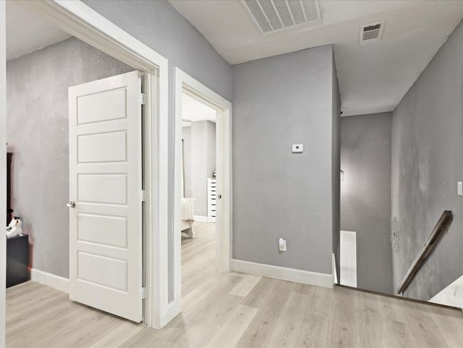 Hallway featuring wood finished floors and baseboards | Image 27
