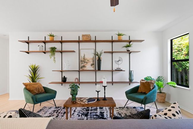 A wall-mounted shelving unit in the room offers a modern touch for storing and showcasing your family heirlooms. | Image 7