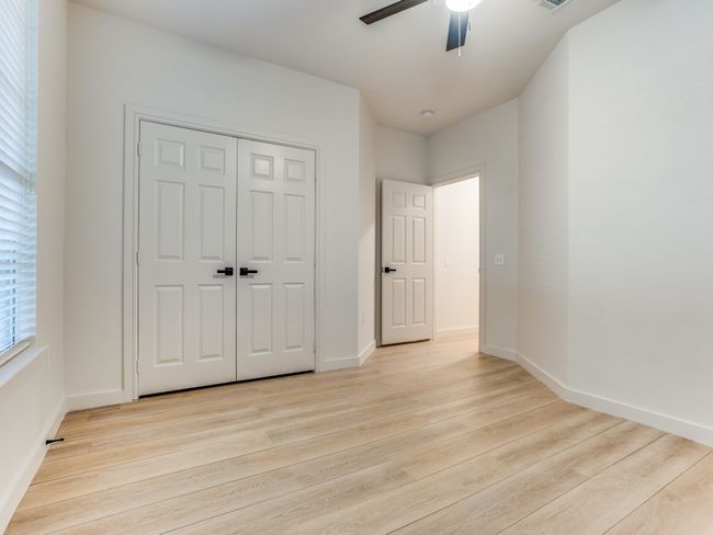 Unfurnished bedroom featuring light wood finished floors, a closet, and ceiling fan | Image 21