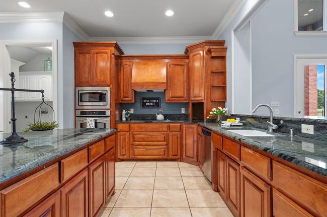 Oversized island with seating possibilities, and endless counter space to accommodate all your kitchen needs. | Image 9