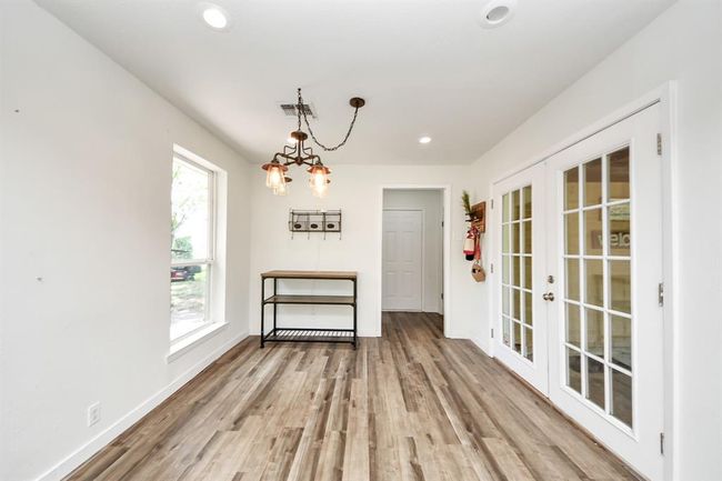 Sunny breakfast space with double doors leading to the side porch—blending indoor comfort with easy outdoor access. | Image 25