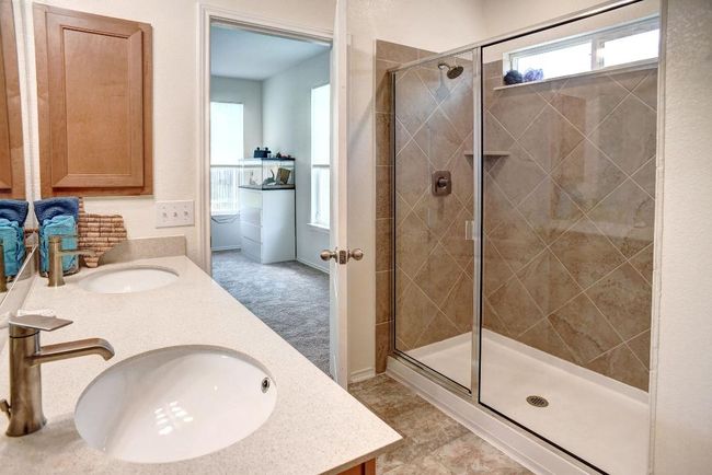 Bathroom featuring double vanity and a stall shower | Image 7