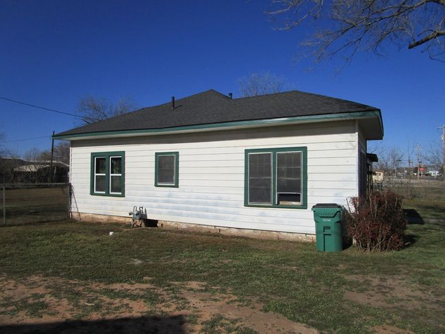 View of home's exterior featuring a lawn and roof with shingles | Image 4