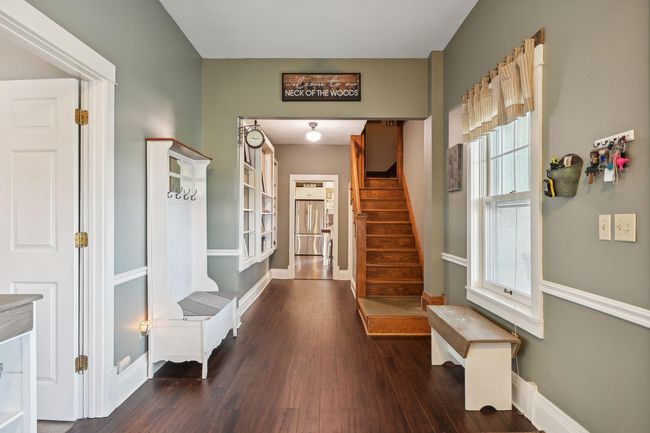 From this view, you can see the remaining area of the foyer, the rear staircase, and the entrance to the spacious kitchen. | Image 9
