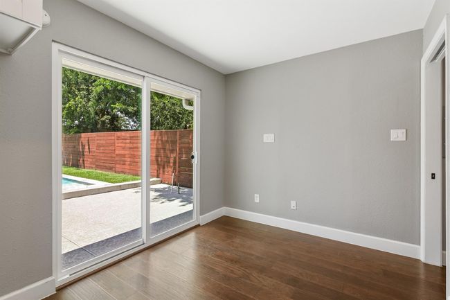 The breakfast room features another set of sliding glass doors with access to the backyard patio. The laundry room is just off the breakfast room to the right. | Image 15