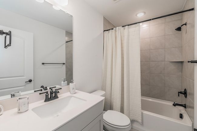 Full bathroom featuring vanity, toilet, and shower / bathtub combination with curtain | Image 30