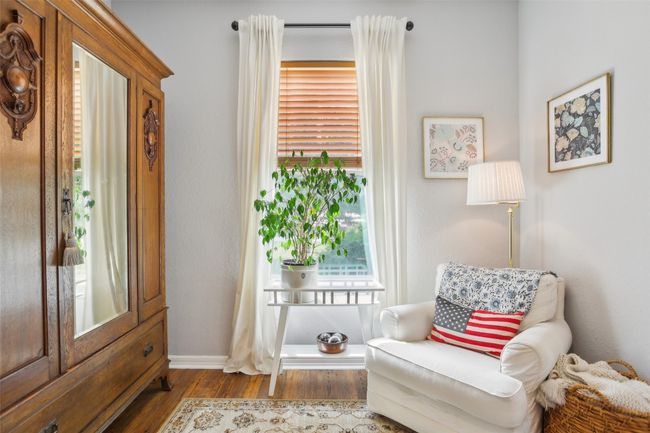 Sitting area with wood plank laminate flooring and baseboards | Image 17